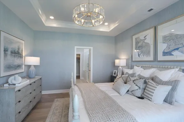 a bedroom with furniture and a chandelier