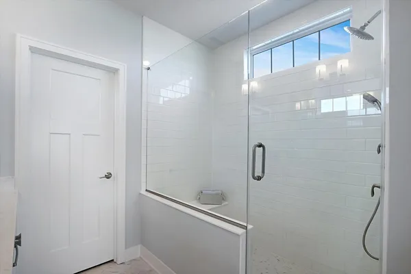 a bathroom with a glass shower door