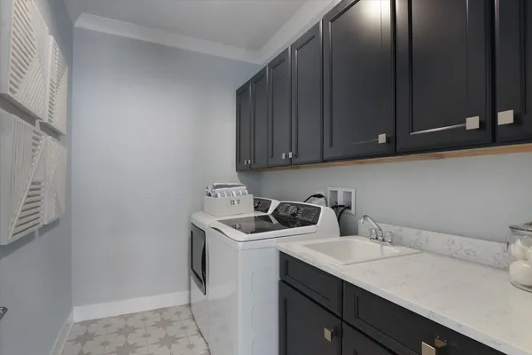 a utility room with sink dryer and washer