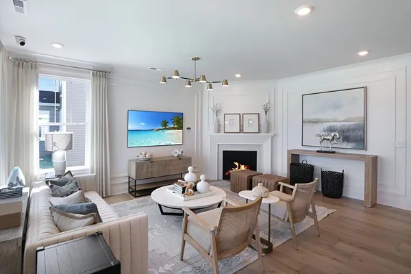 a living room with furniture a fireplace and a table