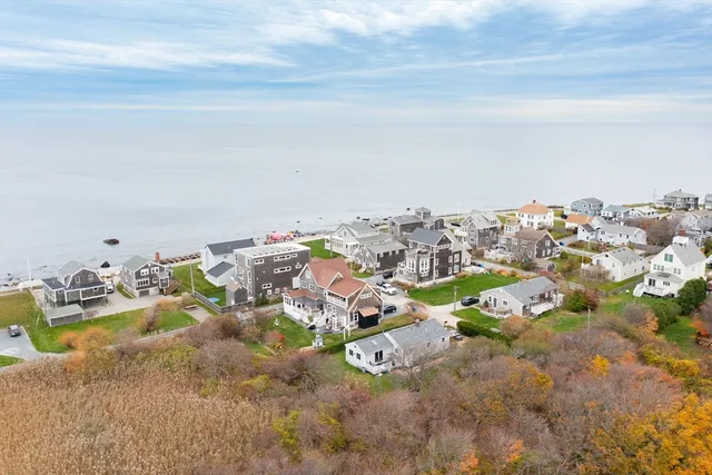 an aerial view of a house with a yard swimming pool and outdoor seating