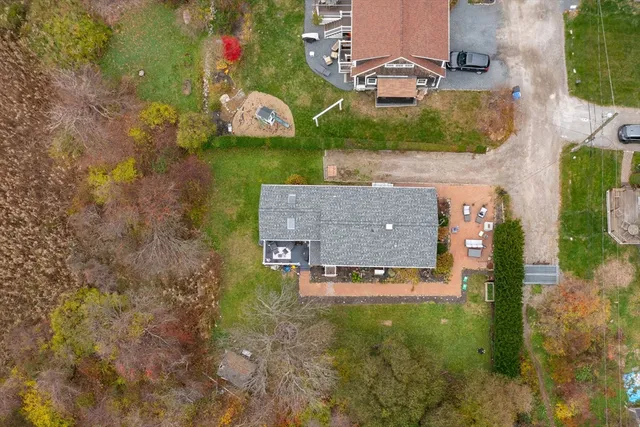an aerial view of a house with a yard