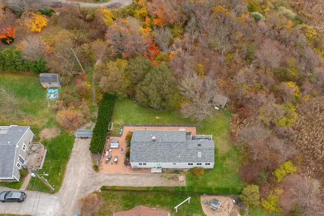 an aerial view of a house with a yard