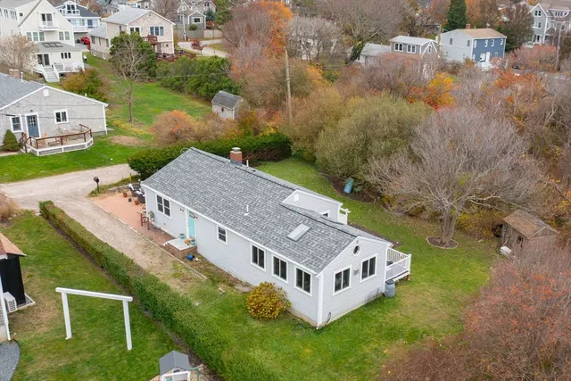 an aerial view of a house with a yard