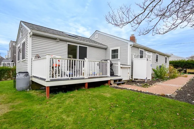 a view of a house with a yard and deck
