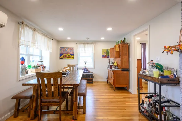 a view of a dining room with furniture window and wooden floor