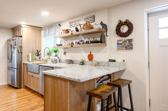 a kitchen with a table and a refrigerator