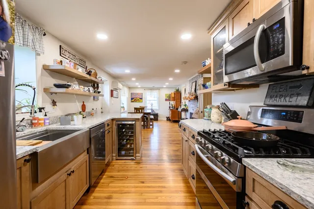 a kitchen with stainless steel appliances granite countertop a stove and a sink