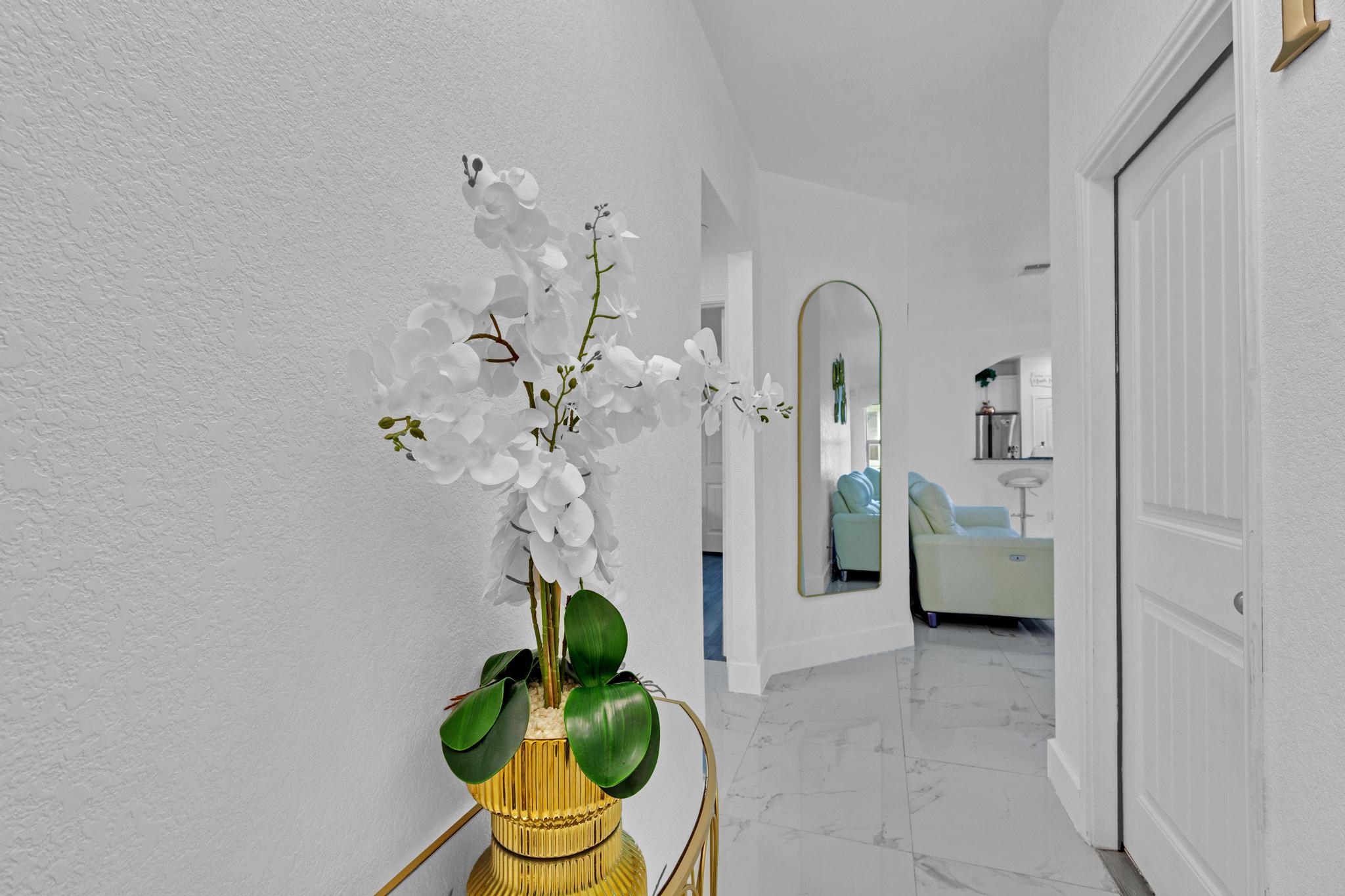 119 Beth Ann Loop Taylor, TX 76574 - Photo 5 of 31 A well-lit entryway welcomes residents and guests with polished floors and a contemporary full-length mirror.