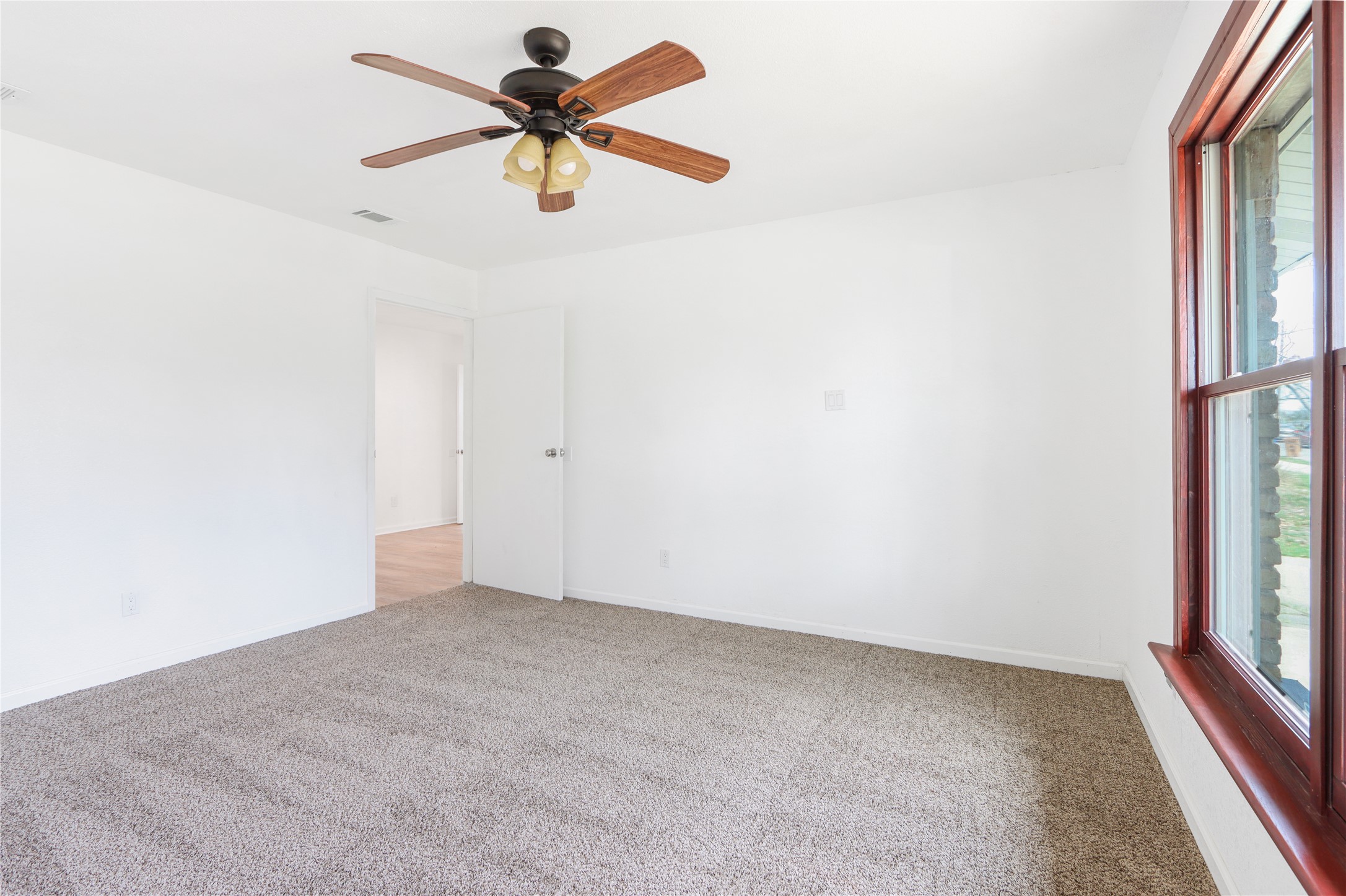 9100 Shepard Drive Austin, TX 78753 - Photo 15 of 26 an empty room with a window and a fan