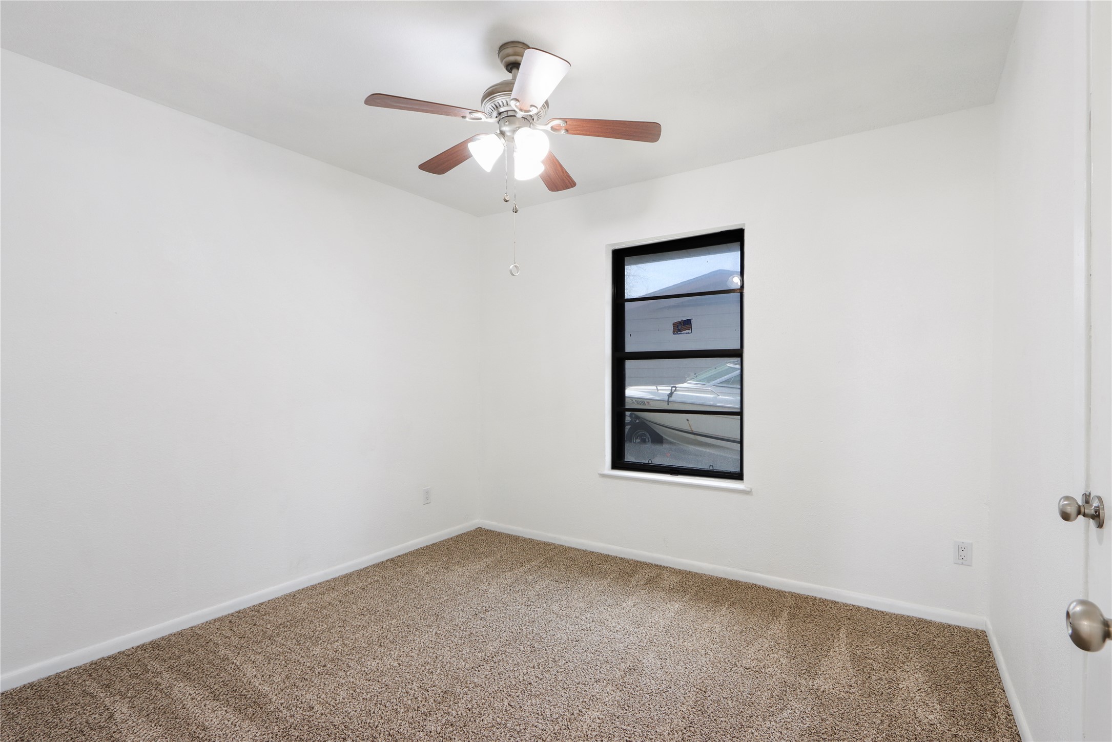 9100 Shepard Drive Austin, TX 78753 - Photo 16 of 26 an empty room with a window and a chandelier fan