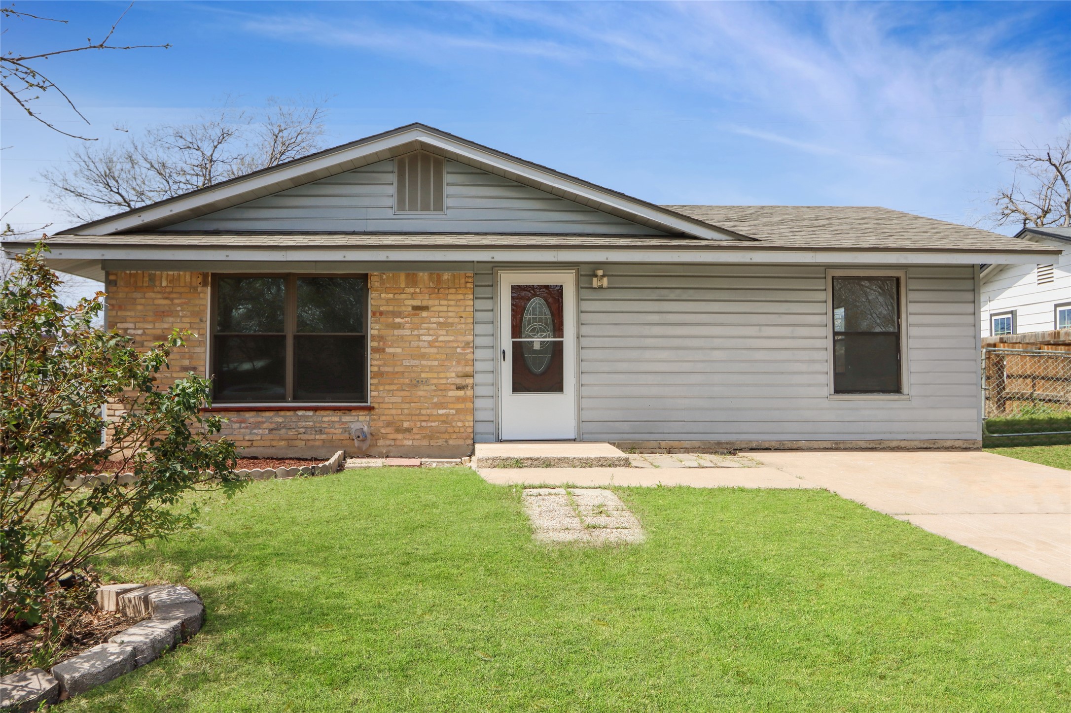 9100 Shepard Drive Austin, TX 78753 - Photo 2 of 26 a front view of a house with a yard and garage