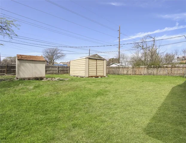 a view of a house with a big yard and large tree