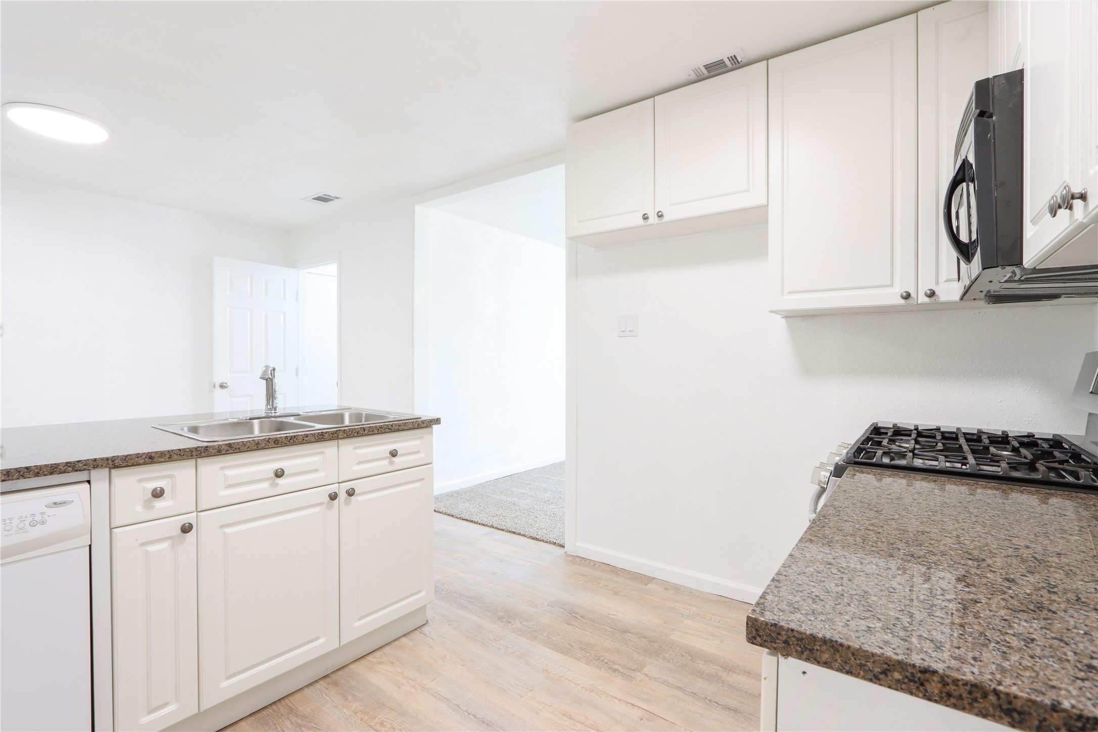 9100 Shepard Drive Austin, TX 78753 - Photo 3 of 26 a kitchen with granite countertop white cabinets and a stove