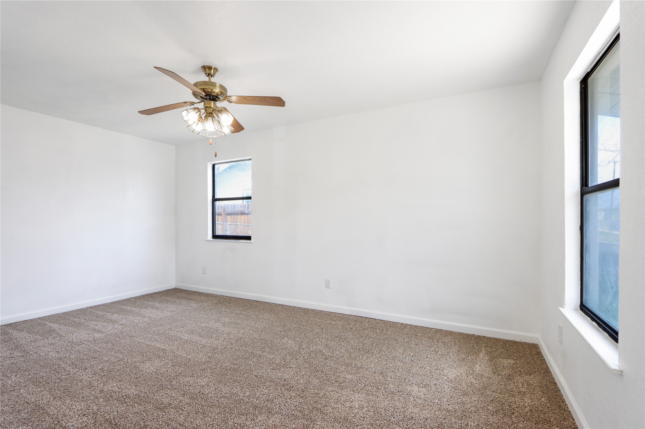 9100 Shepard Drive Austin, TX 78753 - Photo 5 of 26 an empty room with a window and a fan