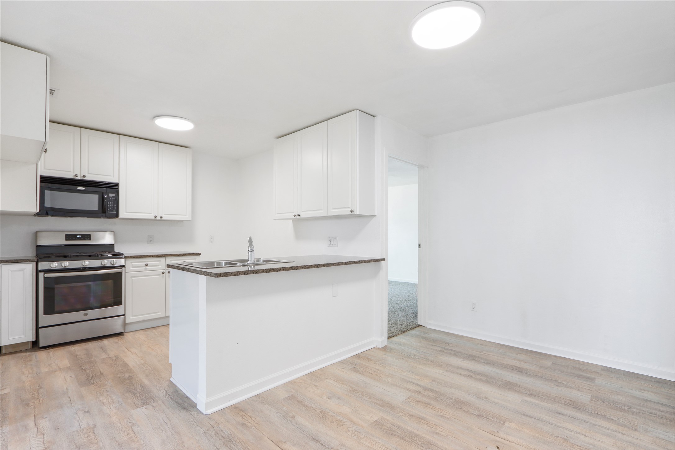 9100 Shepard Drive Austin, TX 78753 - Photo 9 of 26 a kitchen with stainless steel appliances granite countertop a stove a sink and a microwave