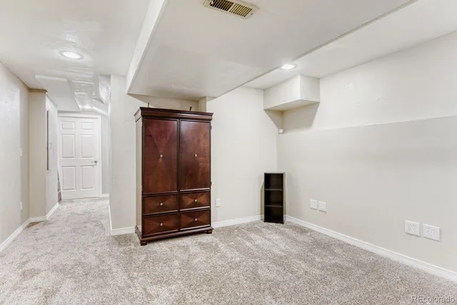 an empty room with closet and cabinet