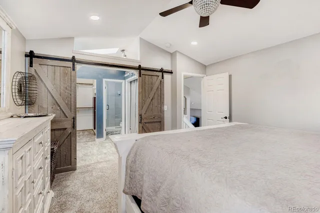 a spacious bathroom with a double vanity sink a mirror and a shower