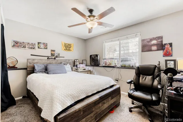 a bedroom with a bed and a large window