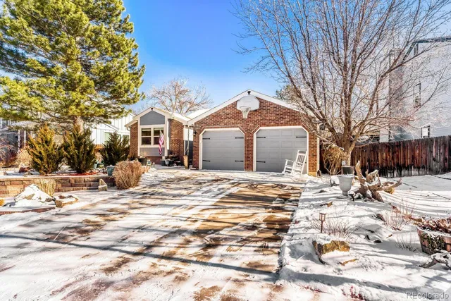 a view of a house with a yard covered in snow