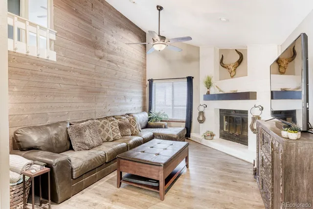a living room with furniture and a fireplace