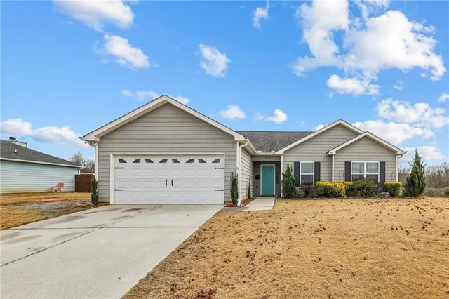 a view of garage yard and front view of a house