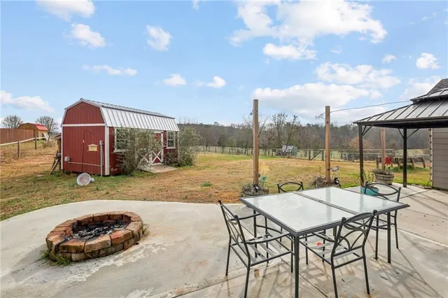 a view of a patio with a table and chairs