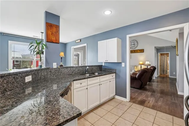 a spacious bathroom with a granite countertop sink and a mirror