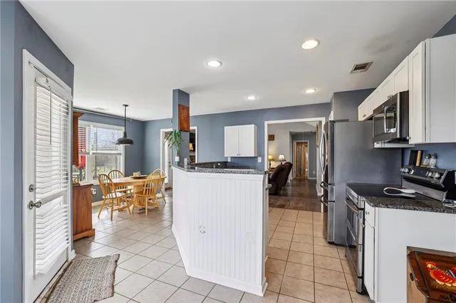 a kitchen with a sink and chairs