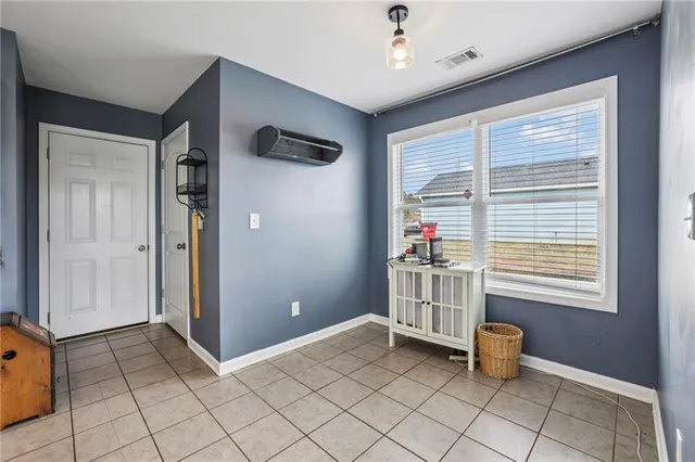 a room that has a chair and a kitchen in it