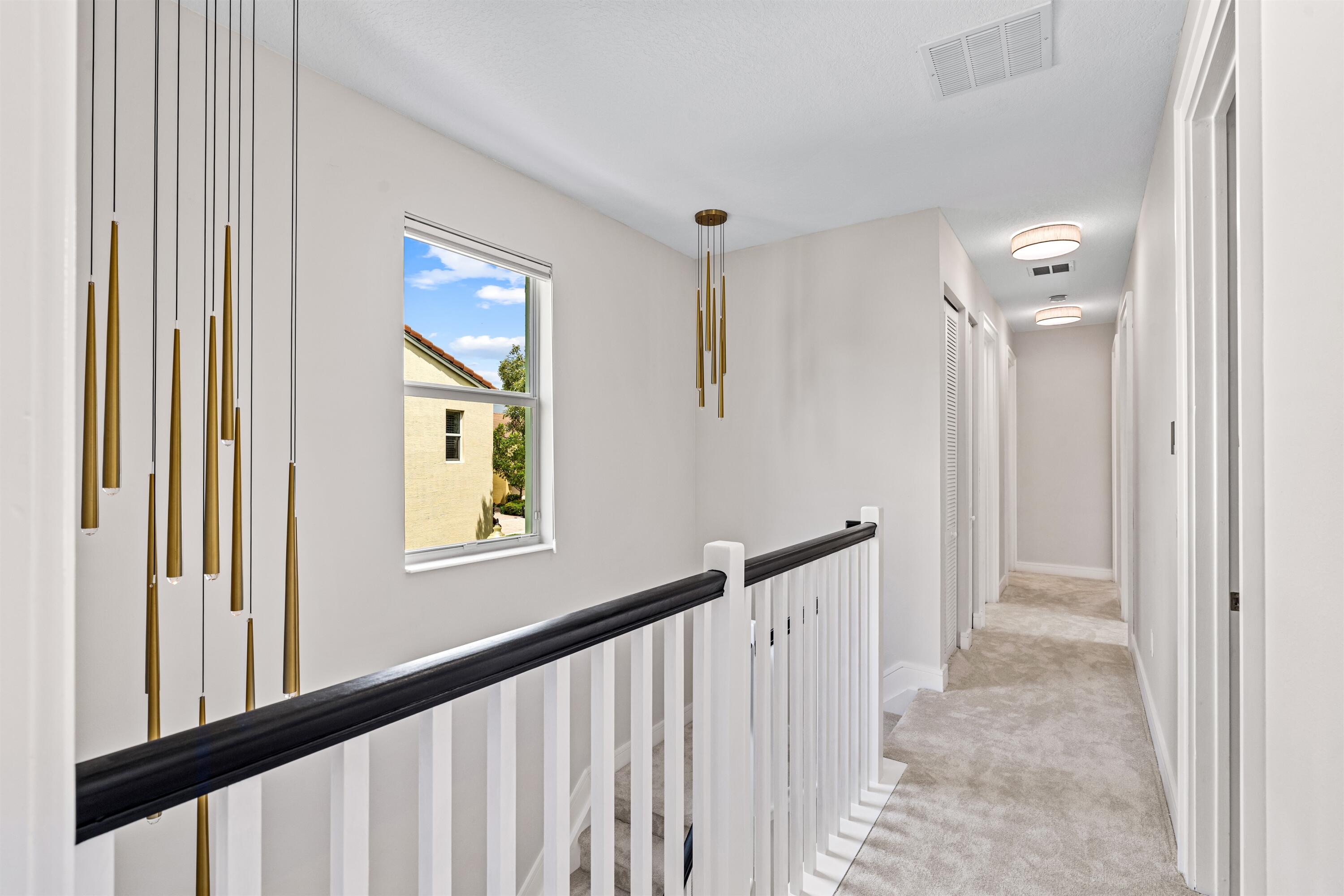 1570 Northwest 48th Place Boca Raton, FL 33431 - Photo 16 of 30 a view of a hallway with windows