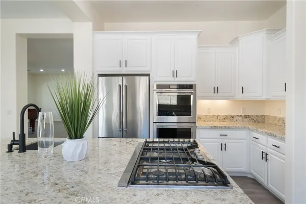 a view of kitchen with refrigerator and wooden floor