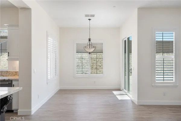 a view of a livingroom with furniture window and wooden floor