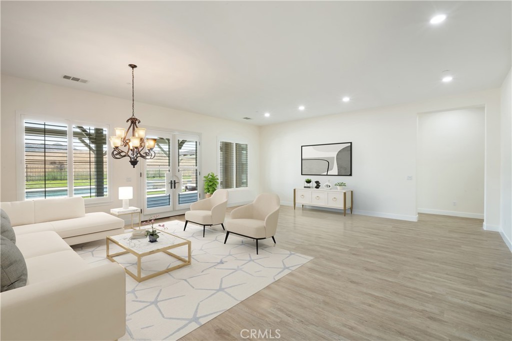 3086 Crystal Ridge Lane Colton, CA 92324 - Photo 19 of 71 a living room with furniture and a chandelier