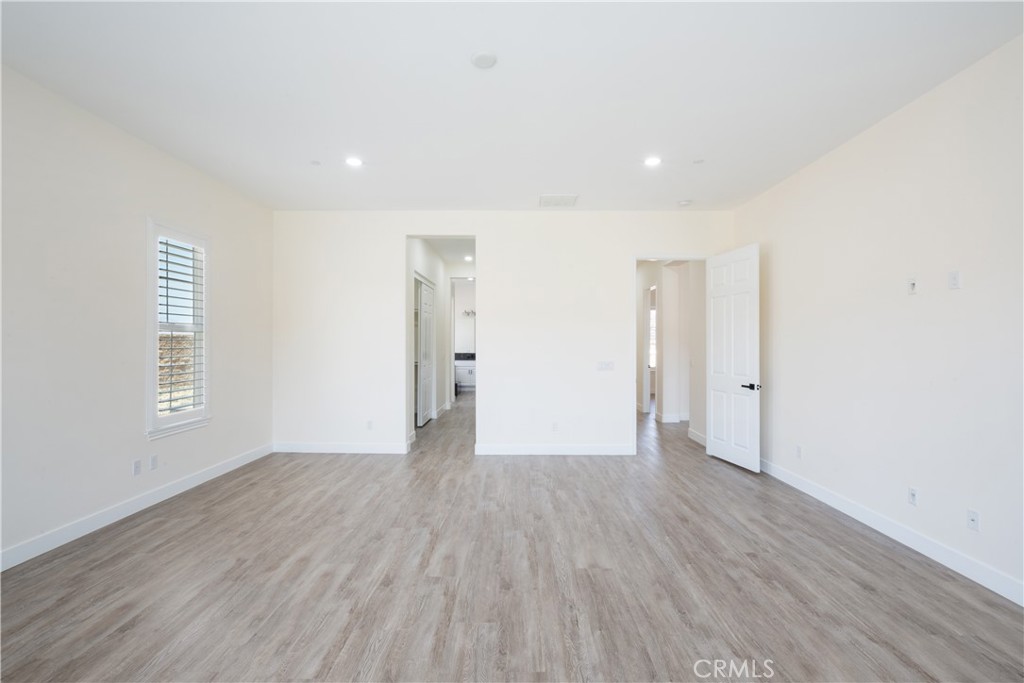 3086 Crystal Ridge Lane Colton, CA 92324 - Photo 25 of 71 a view of an empty room with wooden floor and a window
