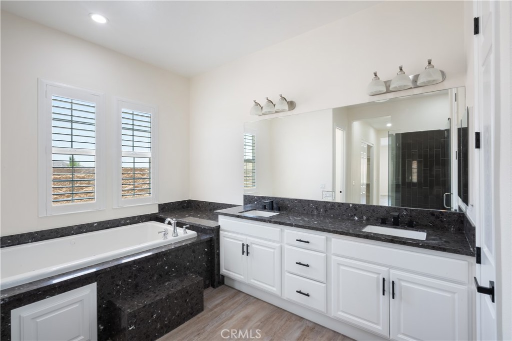 3086 Crystal Ridge Lane Colton, CA 92324 - Photo 27 of 71 a bathroom with a granite countertop sink and a large mirror