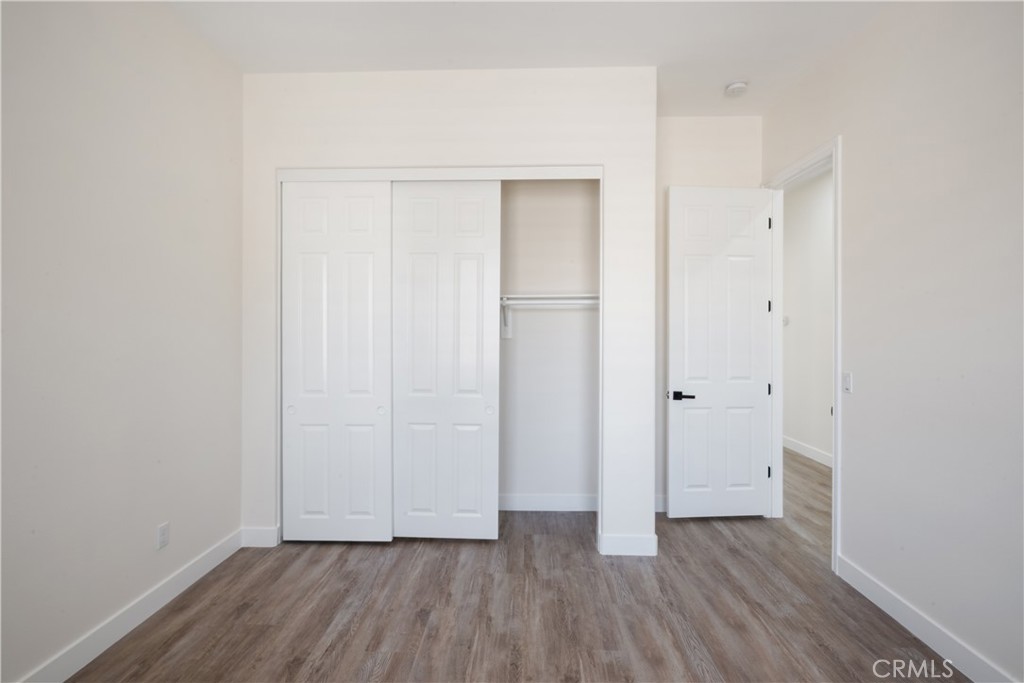 3086 Crystal Ridge Lane Colton, CA 92324 - Photo 33 of 71 a view of an empty room with wooden floor