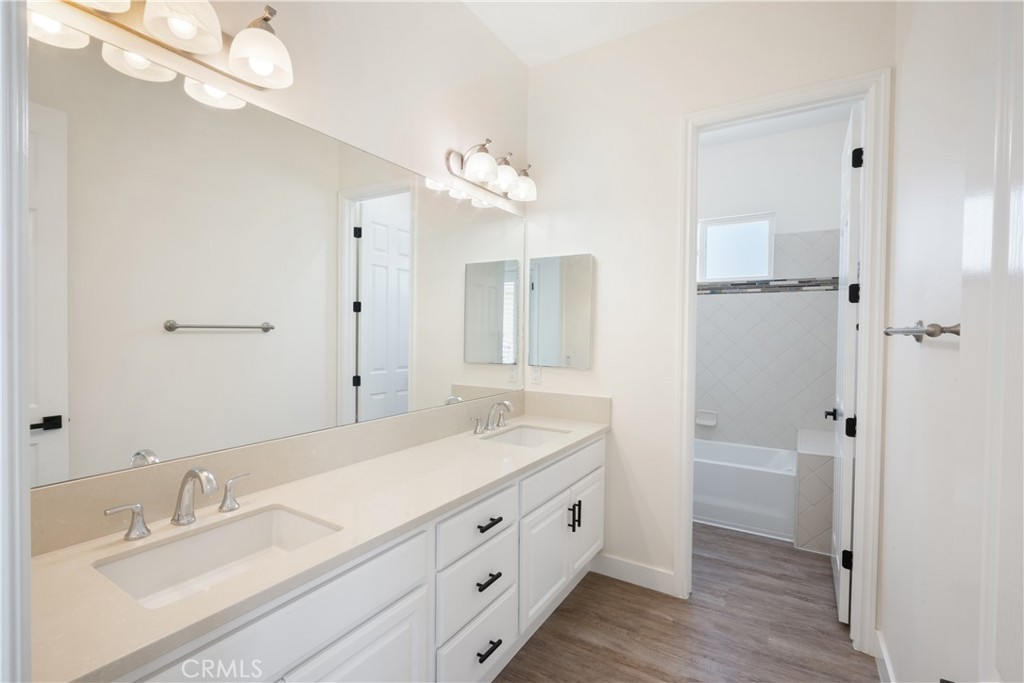 3086 Crystal Ridge Lane Colton, CA 92324 - Photo 34 of 71 a bathroom with a double vanity sink a mirror and a shower