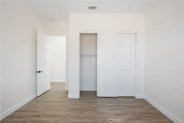 a kitchen with white cabinets and sink
