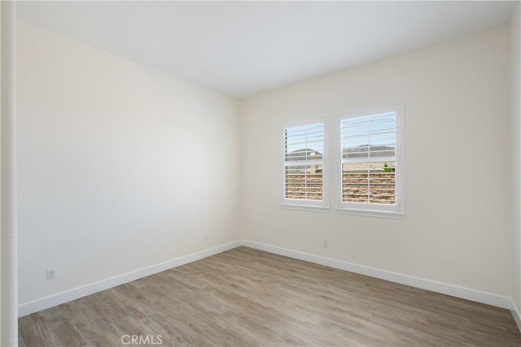 3086 Crystal Ridge Lane Colton, CA 92324 - Photo 37 of 71 an empty room with wooden floor and windows