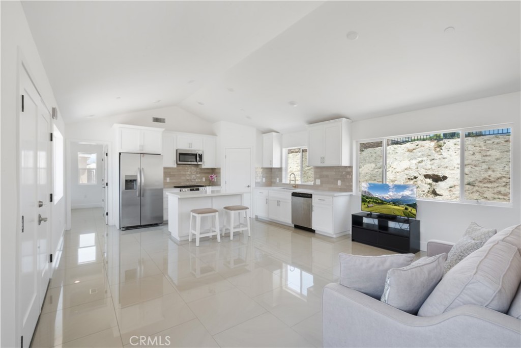 3086 Crystal Ridge Lane Colton, CA 92324 - Photo 49 of 71 a kitchen with stainless steel appliances kitchen island granite countertop a refrigerator and a stove top oven