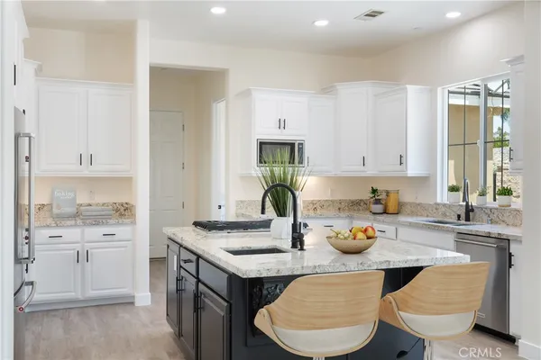 a kitchen with a stove and a refrigerator