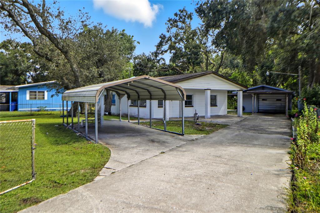 a view of a house with a yard and sitting area