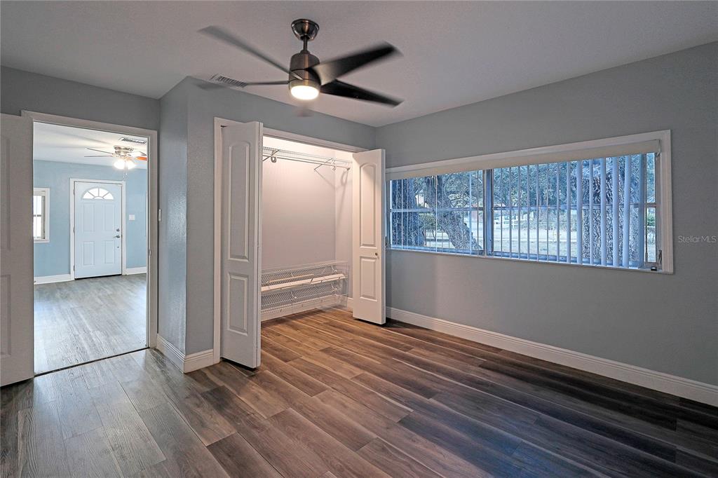 2011 East 148th Avenue Lutz, FL 33559 - Photo 11 of 37 wooden floor in an empty room with a window