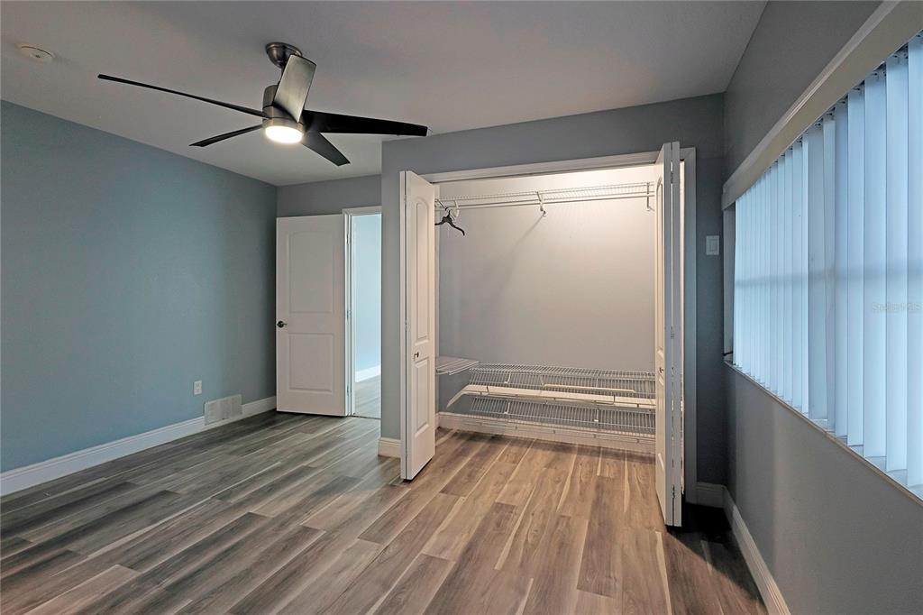 2011 East 148th Avenue Lutz, FL 33559 - Photo 12 of 37 a view of an empty room with wooden floor and a window