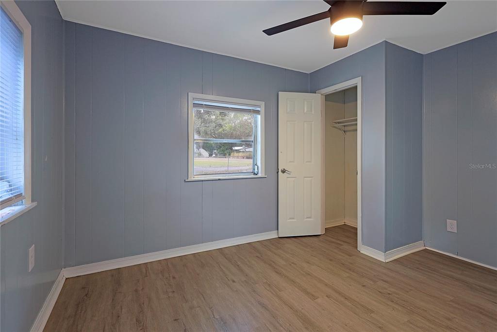 2011 East 148th Avenue Lutz, FL 33559 - Photo 17 of 37 an empty room with wooden floor and windows