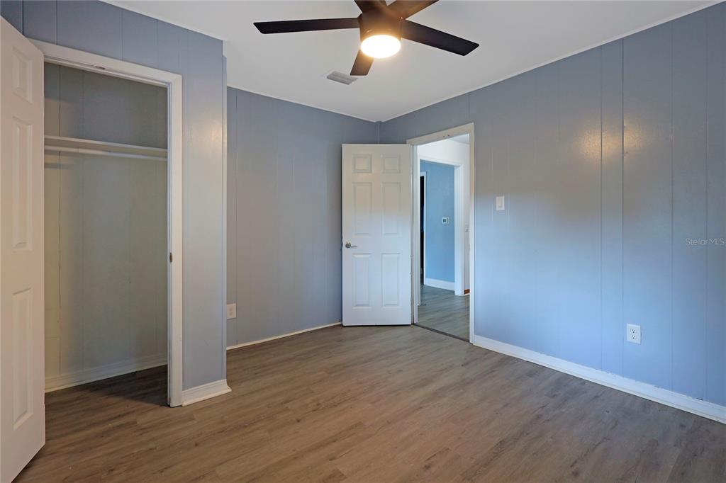 2011 East 148th Avenue Lutz, FL 33559 - Photo 18 of 37 a view of an empty room with wooden floor