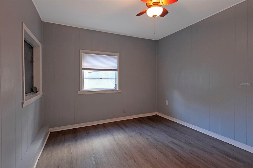 2011 East 148th Avenue Lutz, FL 33559 - Photo 20 of 37 wooden floor in an empty room with a window