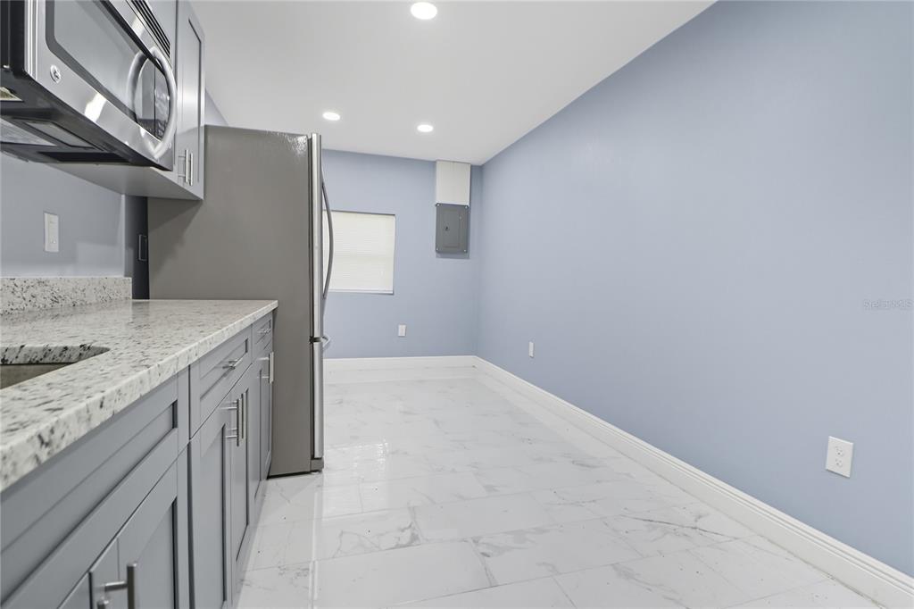 2011 East 148th Avenue Lutz, FL 33559 - Photo 27 of 37 a bathroom with a granite countertop sink and washing machine