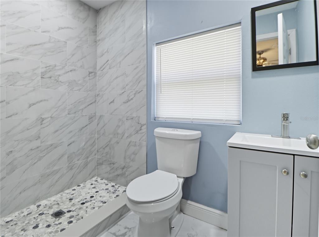 2011 East 148th Avenue Lutz, FL 33559 - Photo 29 of 37 a bathroom with a toilet sink and mirror